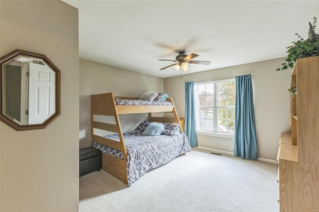 bedroom with ceiling fan and light carpet