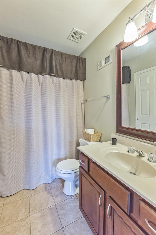 bathroom with tile patterned floors, vanity, and toilet