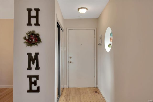 hall with light hardwood / wood-style floors