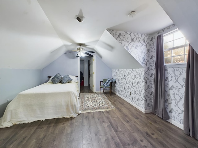 bedroom with ceiling fan, dark hardwood / wood-style flooring, and lofted ceiling