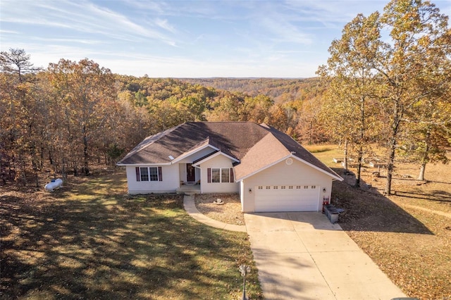 ranch-style house featuring a garage and a front lawn