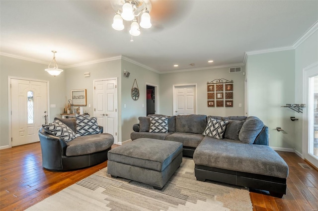 living room featuring a wealth of natural light, light hardwood / wood-style flooring, and ornamental molding