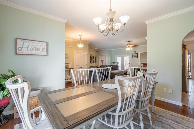 dining space featuring ceiling fan with notable chandelier, dark hardwood / wood-style floors, and crown molding