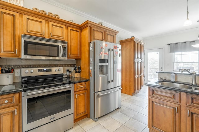 kitchen featuring stainless steel appliances, sink, dark stone counters, light tile patterned floors, and crown molding