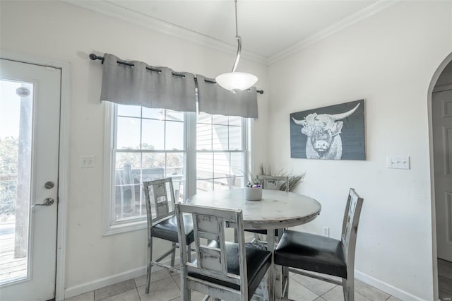 dining space featuring light tile patterned floors and crown molding