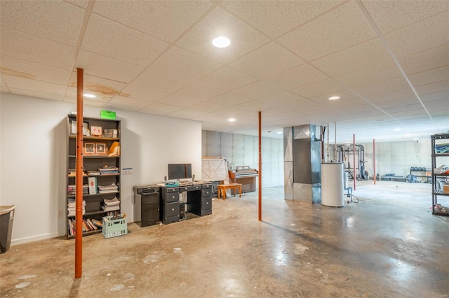 basement featuring water heater and a drop ceiling