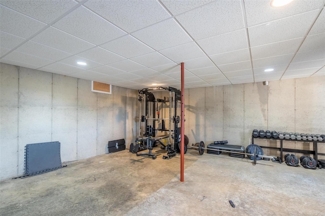 workout room with a drop ceiling and concrete flooring