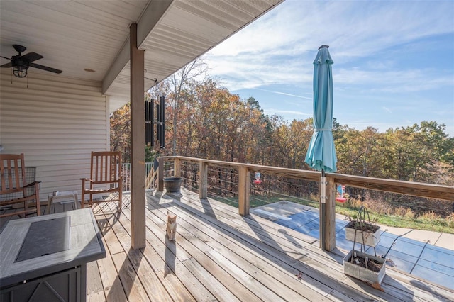 wooden terrace featuring a fire pit and ceiling fan