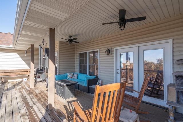 deck featuring ceiling fan and an outdoor living space