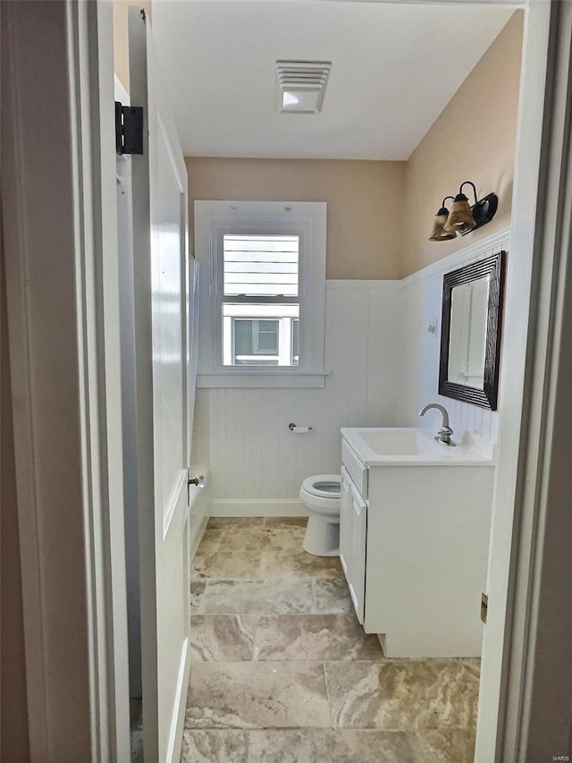 bathroom featuring vanity and toilet