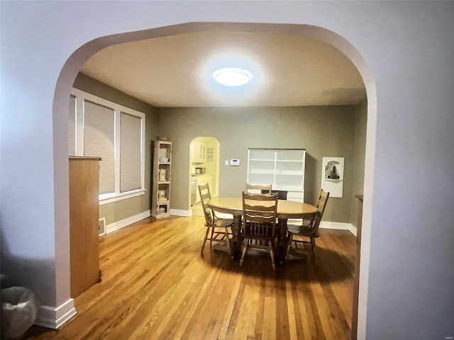 dining space with hardwood / wood-style flooring