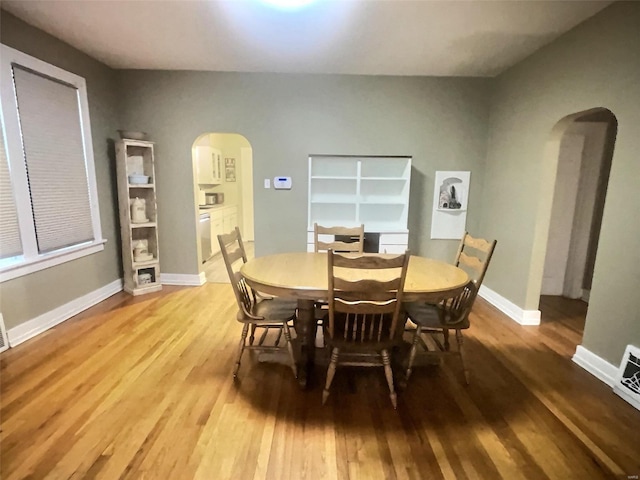 dining space with light hardwood / wood-style flooring