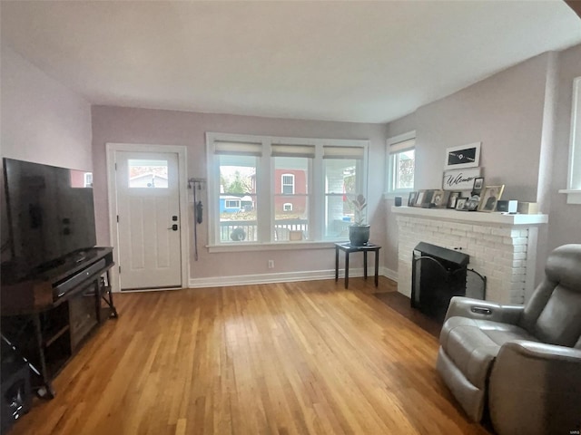 living room featuring a fireplace and light wood-type flooring