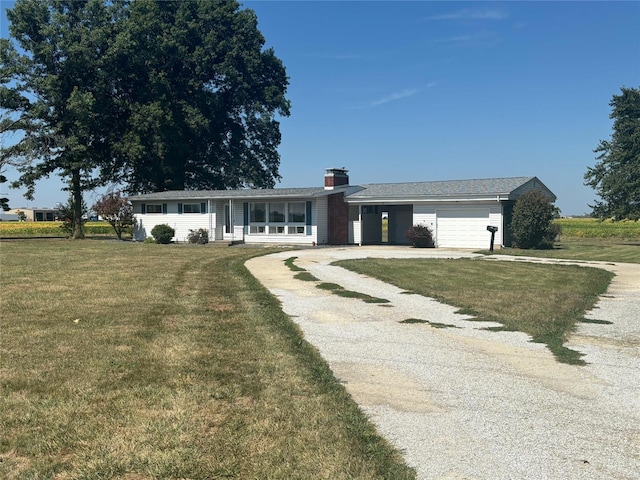 ranch-style home with a garage and a front lawn