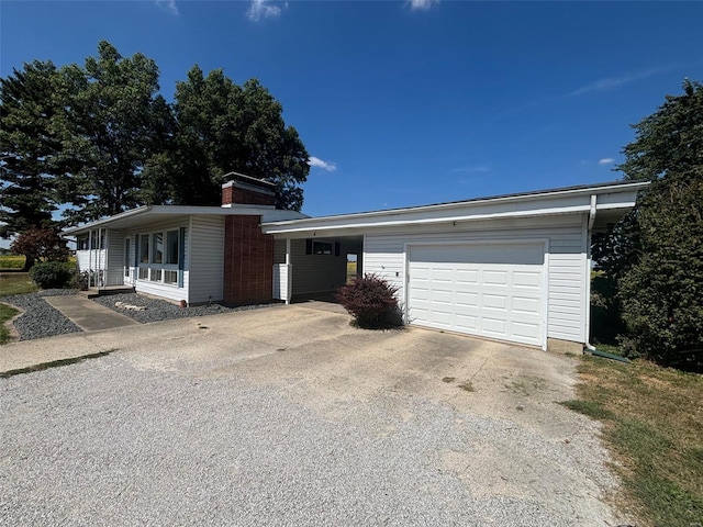 ranch-style house featuring a garage, a carport, and a porch