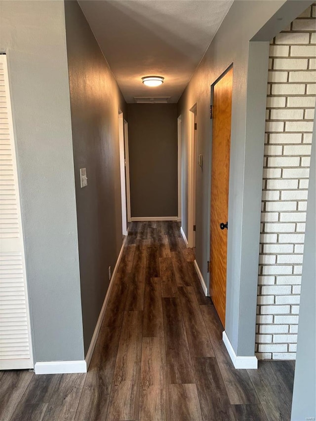 corridor featuring dark hardwood / wood-style floors