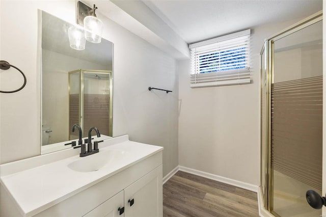 bathroom with vanity, wood-type flooring, and walk in shower