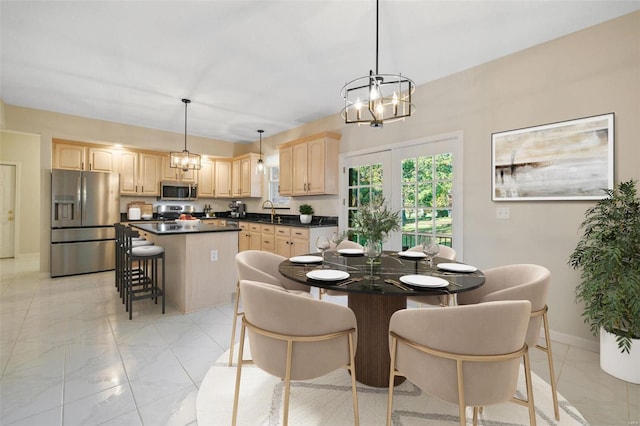 dining room with a chandelier and light tile patterned floors