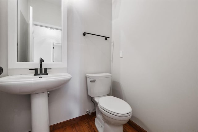 bathroom with sink, wood-type flooring, and toilet