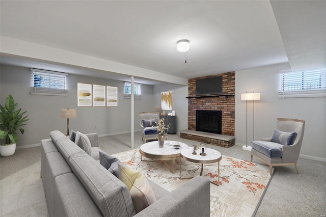 carpeted living room featuring plenty of natural light and a brick fireplace