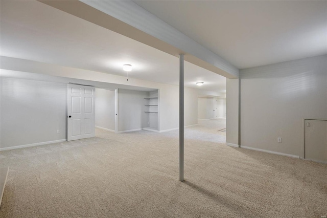 basement featuring light colored carpet