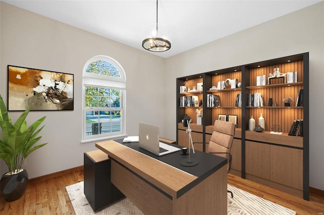 home office featuring an inviting chandelier and light hardwood / wood-style flooring