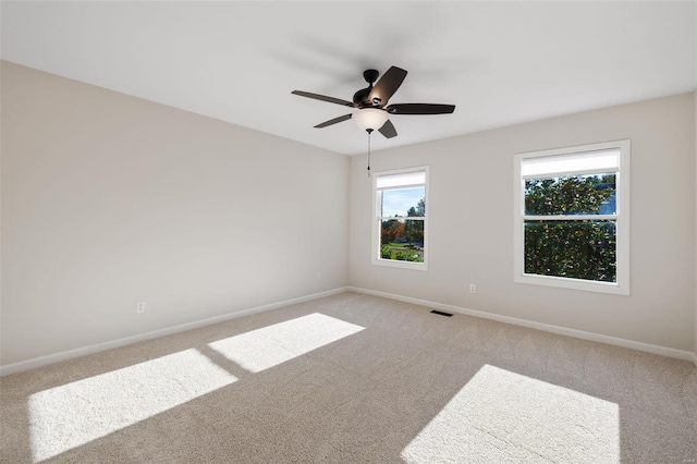 carpeted empty room with ceiling fan