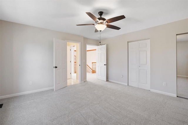 unfurnished bedroom with light colored carpet and ceiling fan