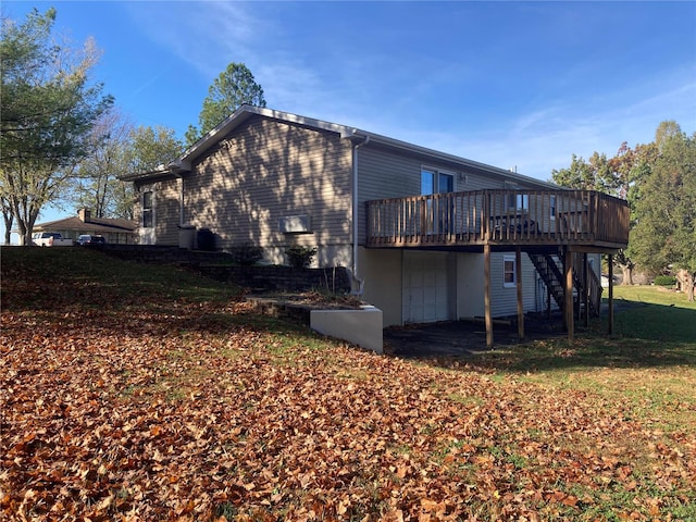 rear view of property with a lawn and a deck