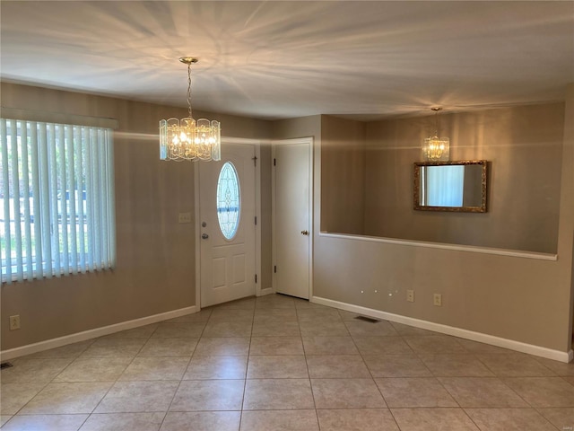 foyer entrance featuring a chandelier and light tile patterned floors