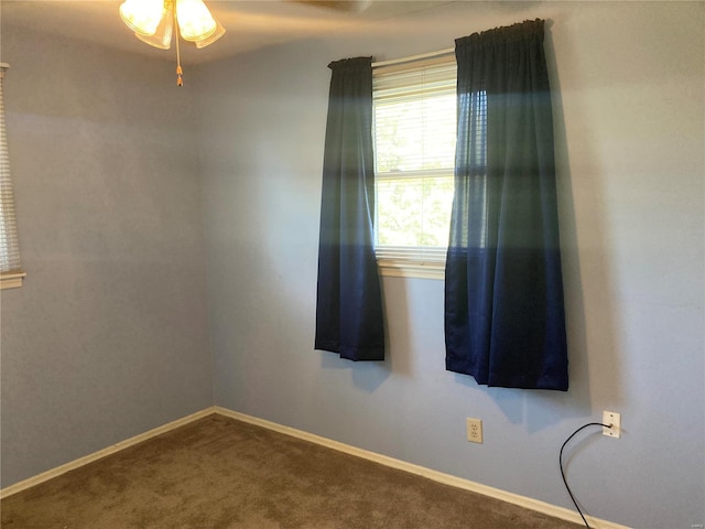 empty room with ceiling fan and carpet flooring