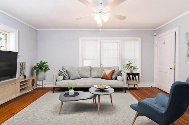 living room featuring wood-type flooring, ceiling fan, and crown molding