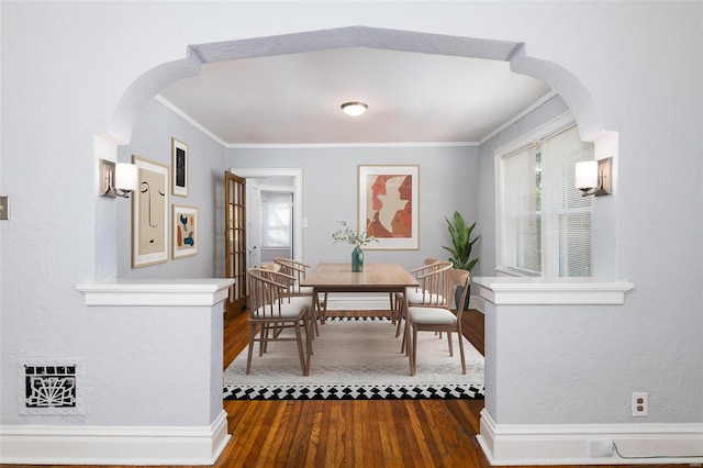 dining space featuring dark hardwood / wood-style flooring and ornamental molding