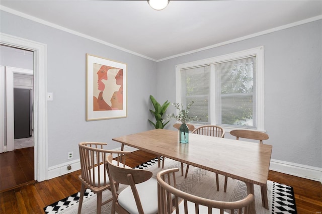 dining area featuring ornamental molding and dark wood-type flooring