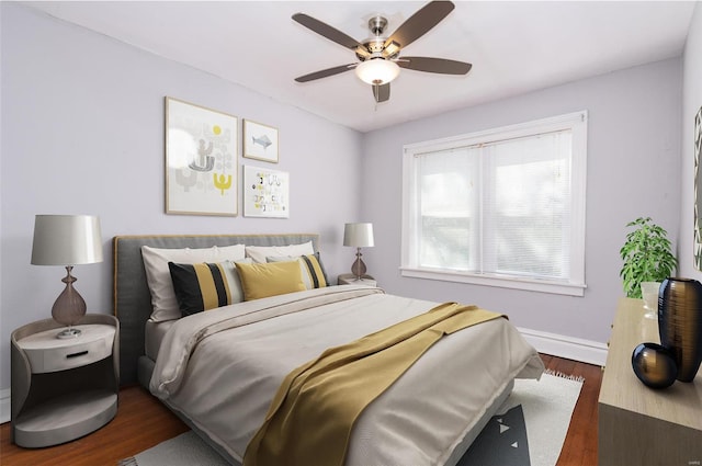 bedroom with ceiling fan and dark wood-type flooring