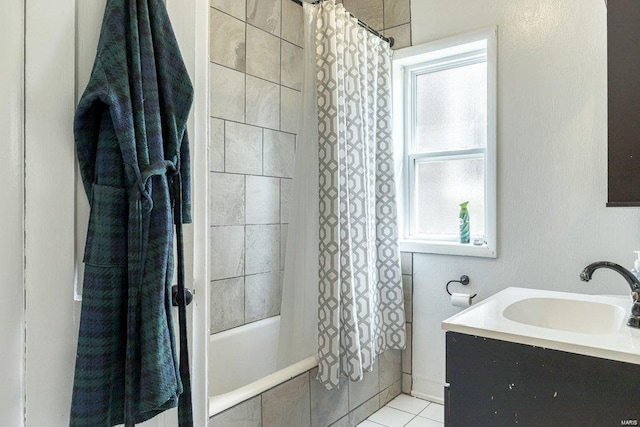 bathroom featuring tile patterned flooring, vanity, and shower / tub combo with curtain