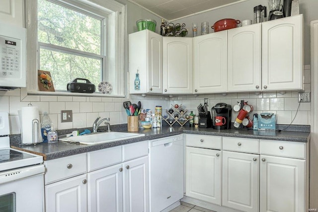 kitchen featuring white cabinets, white appliances, backsplash, and sink