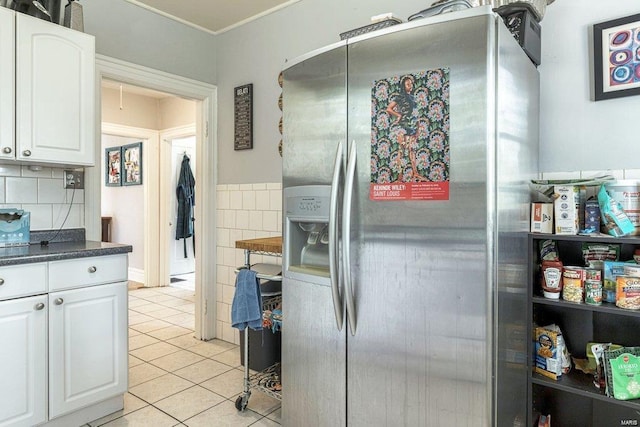 kitchen with white cabinetry, stainless steel fridge, tasteful backsplash, and light tile patterned floors