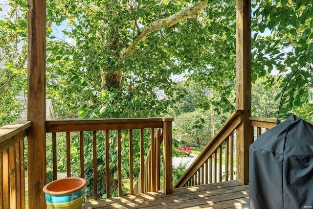 wooden deck featuring a grill