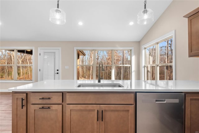 kitchen featuring dishwasher, decorative light fixtures, lofted ceiling, and sink