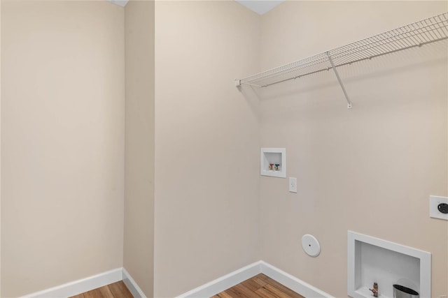 clothes washing area with washer hookup, electric dryer hookup, hookup for a gas dryer, and hardwood / wood-style floors