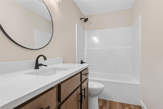 full bathroom with bathtub / shower combination, wood-type flooring, vanity, and toilet