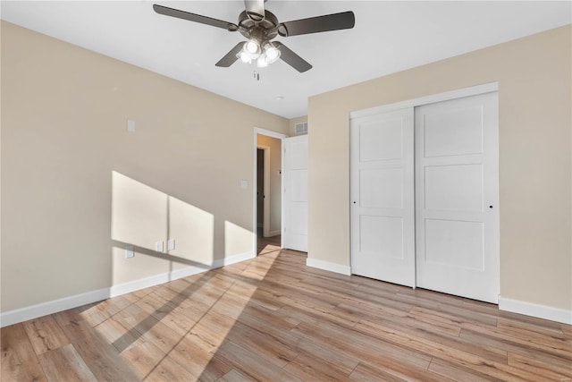 unfurnished bedroom with ceiling fan, a closet, and light hardwood / wood-style flooring