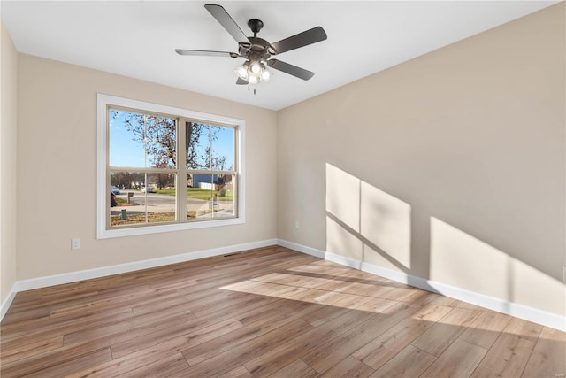 spare room with ceiling fan and light wood-type flooring