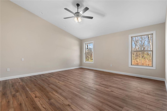 empty room with hardwood / wood-style flooring, ceiling fan, and lofted ceiling