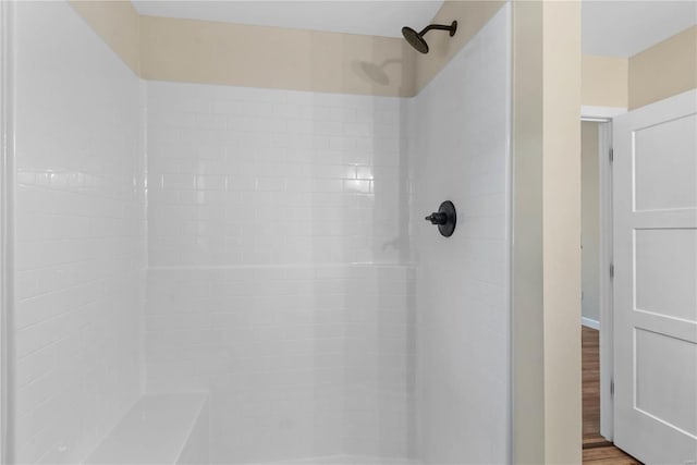 bathroom with hardwood / wood-style floors and walk in shower