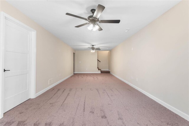 interior space featuring light colored carpet and ceiling fan