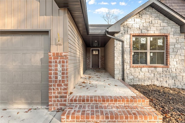 view of exterior entry with a garage