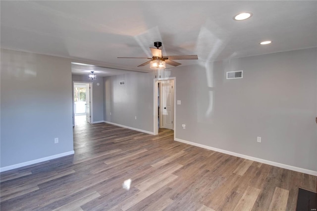 spare room with hardwood / wood-style flooring and ceiling fan