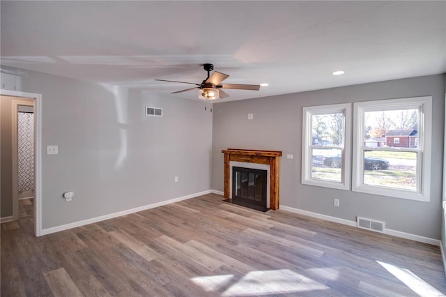 unfurnished living room featuring ceiling fan and light hardwood / wood-style floors